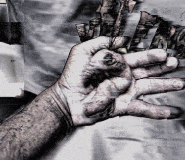a black and white photo of a person 's hand in front of a sign that says ' ucla '