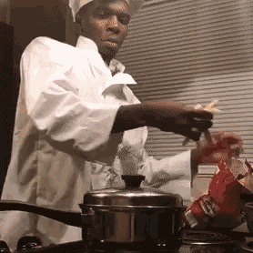 a man in a chef 's hat is cooking potatoes on a stove .