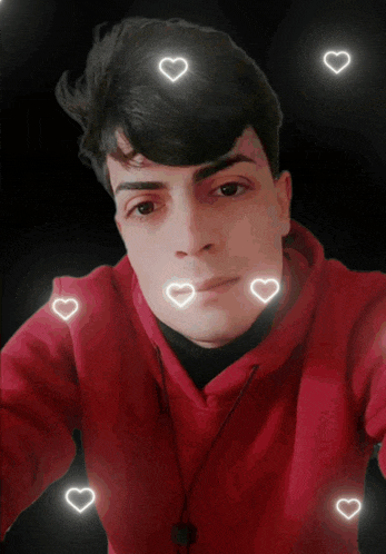 a young man in a red hoodie is surrounded by hearts