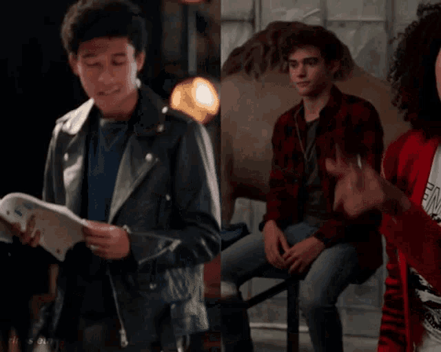 a young man in a leather jacket is reading a book