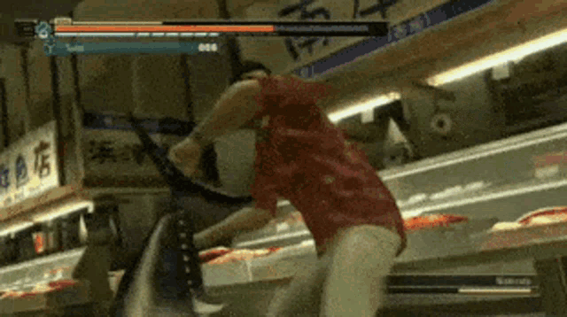 a man in a red shirt is fighting a large fish