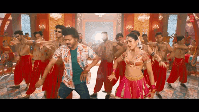a man and a woman are dancing in front of a group of people .