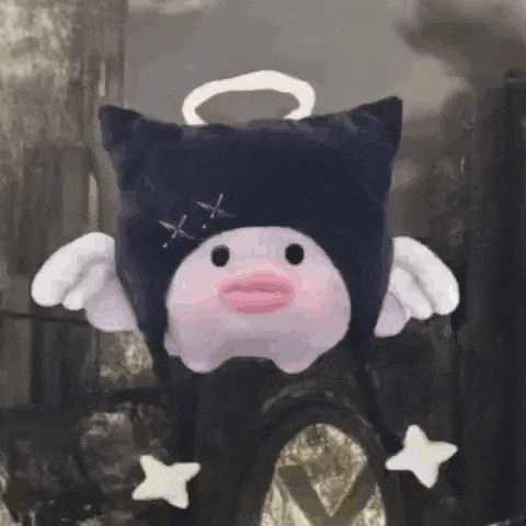a stuffed animal with wings and a halo is wearing a cat hat .