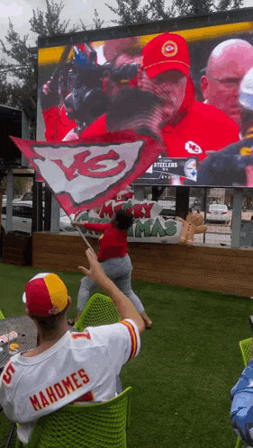 a man in a mahomes jersey watches a game