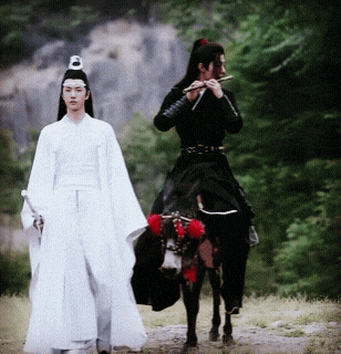 a man playing a flute next to a man on a horse
