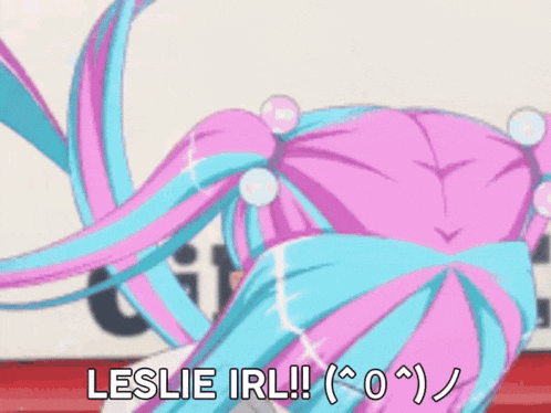 a girl with pink and blue hair is singing with her eyes closed and the words leslie irl !