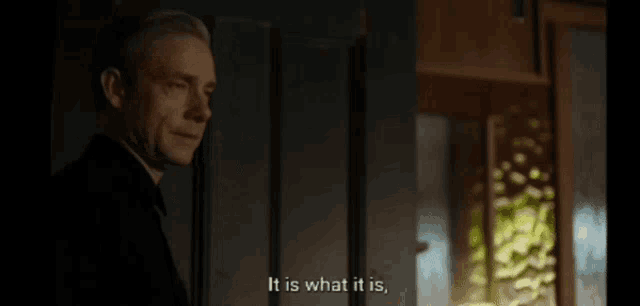 a man is standing in front of a door and saying " and what it is shit "