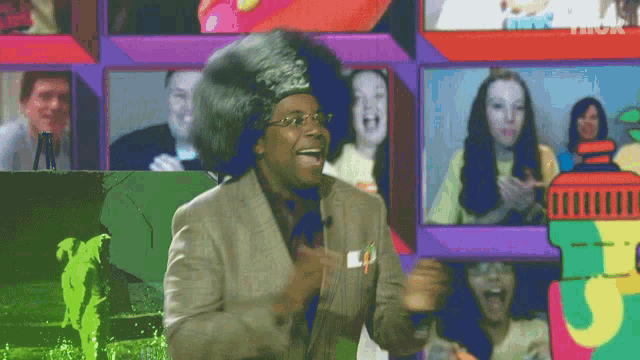 a man wearing a wig and glasses stands in front of a collage of pictures
