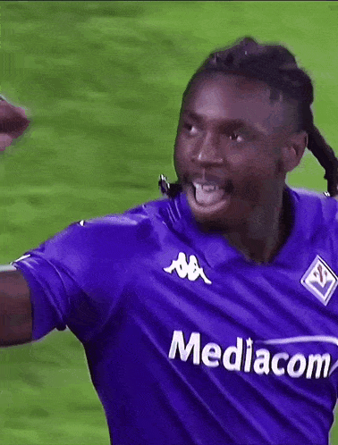 a soccer player wearing a purple jersey with mediacom on it