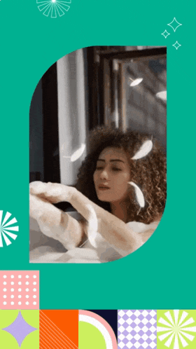 a woman with curly hair is taking a bath in a tub