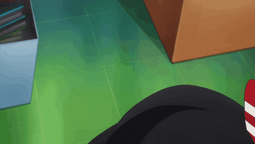 a person is laying on a green tiled floor next to a box