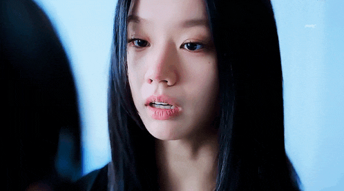 a close up of a woman 's face with her mouth open