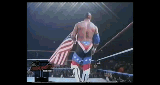 a wrestler with an american flag painted on his pants walks out of the ring