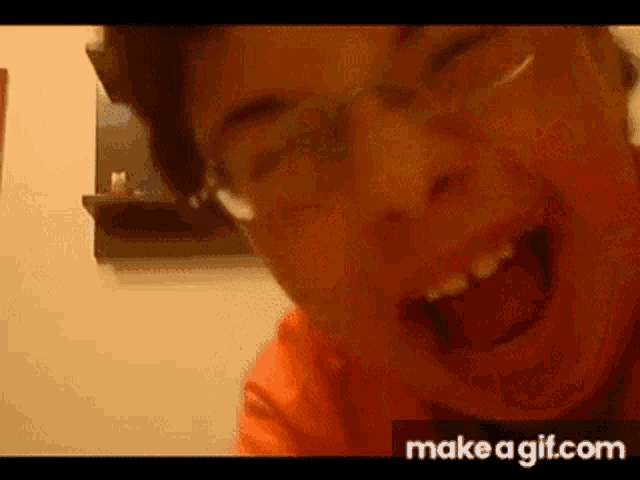 a man wearing glasses is making a funny face .