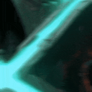 a blurred image of a person 's face with a blue light coming out of it