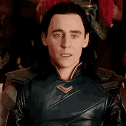 a close up of a man in a leather jacket making a silly face .