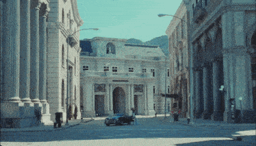 a car is parked in front of a building that says ' a ' on the front