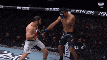 two men are fighting in a cage with a sign that says true classic