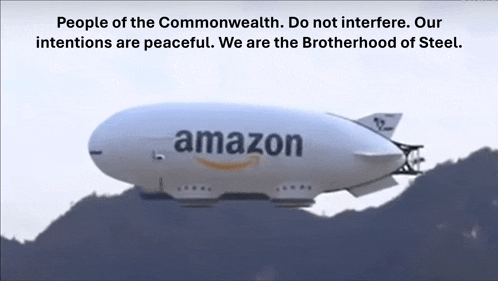 an amazon airship is flying over a hill
