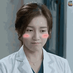 a close up of a woman wearing a white lab coat