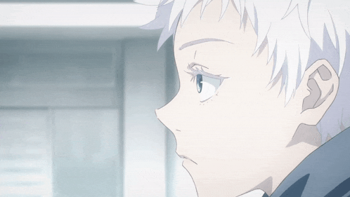 a close up of a boy 's face with white hair