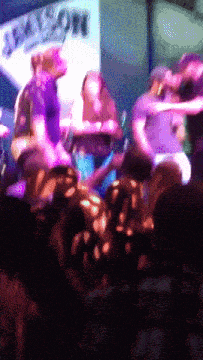 a blurry picture of a group of people playing instruments in front of a sign that says ' jackson '