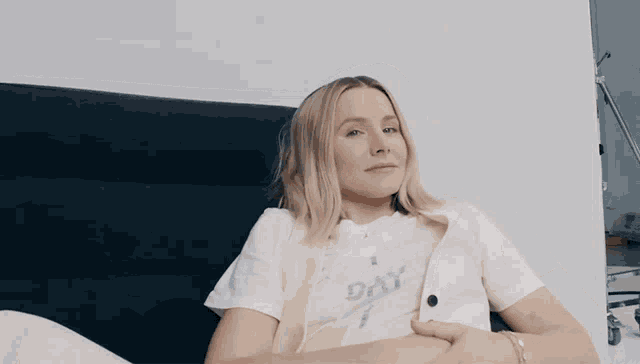 a woman wearing a white shirt that says day