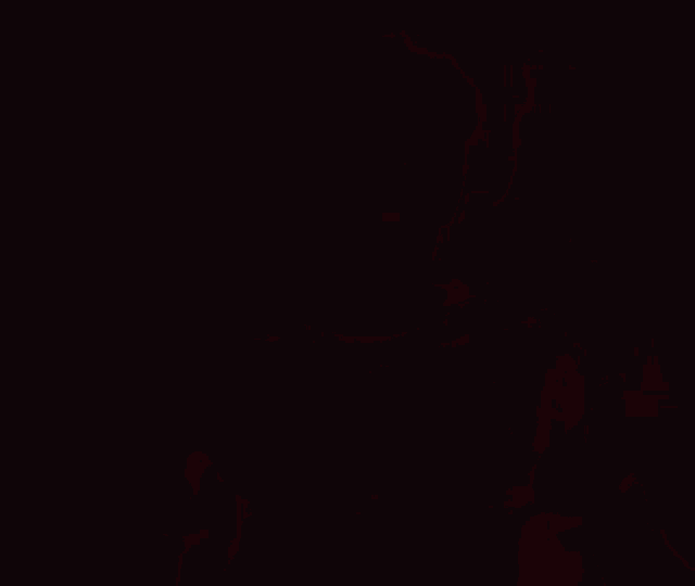 a blurry picture of a man in a black shirt in a red light