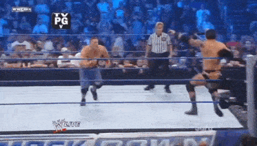 two wrestlers are in a wrestling ring with a referee and a tv pg logo in the background