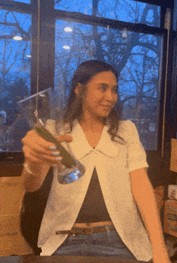 a woman sitting at a table with a box that says best blend in the background