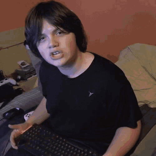 a boy wearing a black shirt with the letter y on the left side