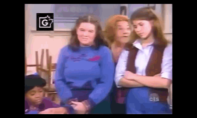 a group of girls are standing next to each other with their arms crossed in front of a sign that says cls .