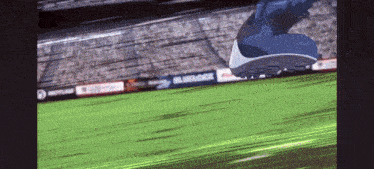 a person is running on a soccer field with a blue and white sign that says bluetock