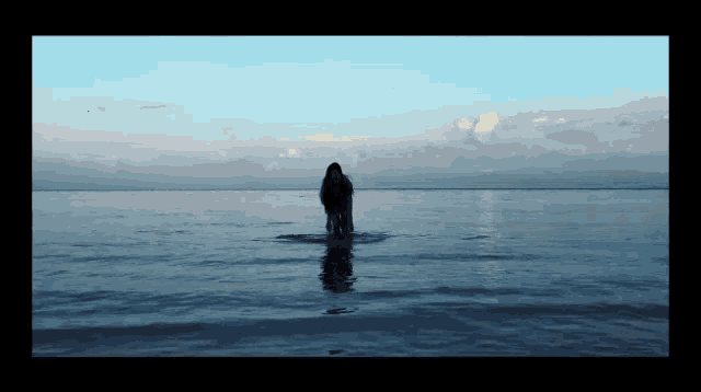 a person is standing in the middle of a body of water
