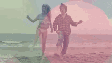 a man and a woman are running on a beach .