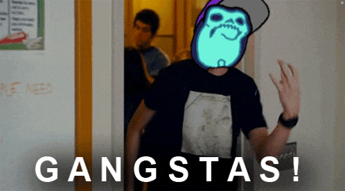 a man wearing a metallica shirt is standing in front of a wall that says gangstas