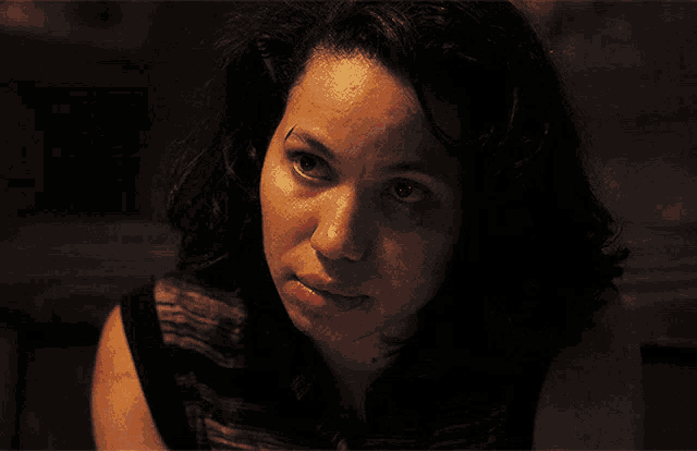 a woman in a dark room with her mouth open