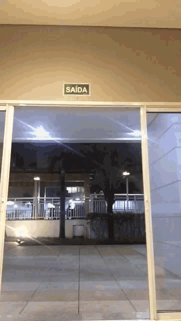 a sliding glass door with a sign on the wall that says saida
