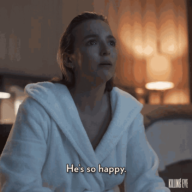 a woman in a white bathrobe says he 's so happy