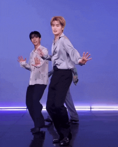 two men are dancing together on a stage .