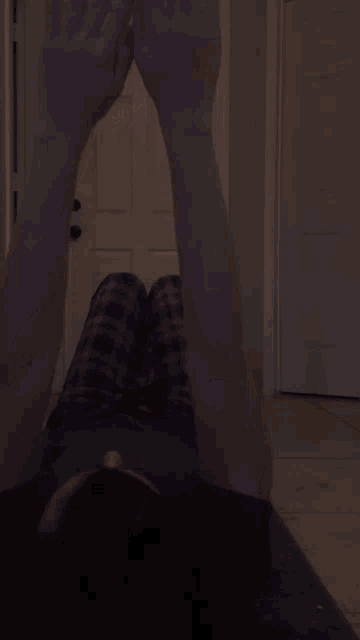 a person laying on their back with their hands up in the air