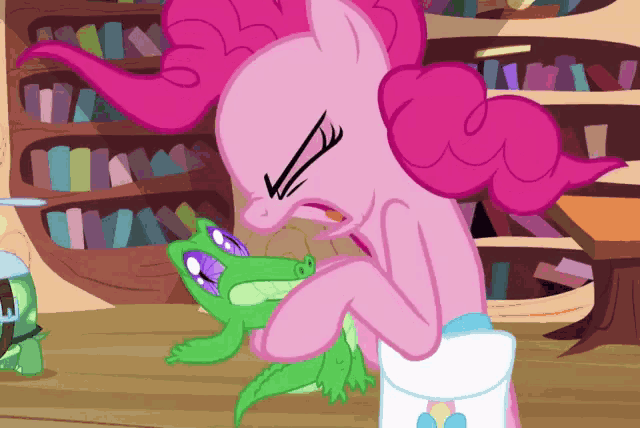 a pink pony is holding a green lizard in a library