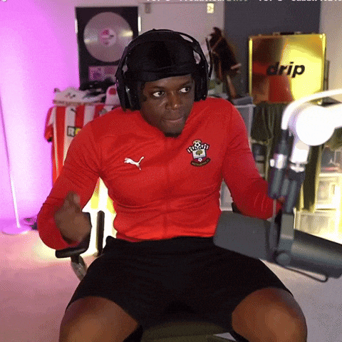 a man wearing headphones and a red puma jacket is sitting in front of a drip box