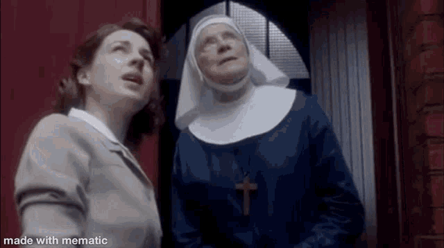 a nun and a woman are standing next to each other in a doorway looking up .