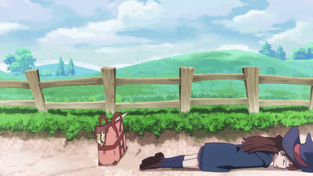 a girl in a witch costume is laying on the ground