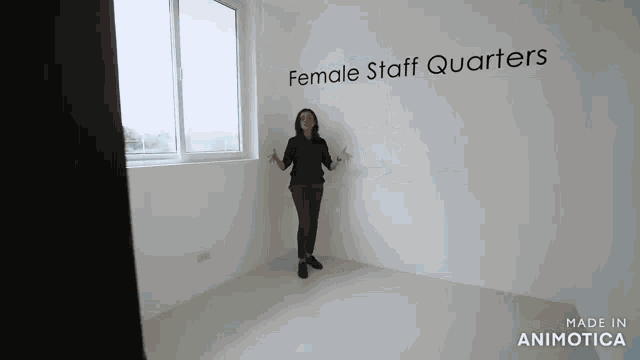 a woman is standing in a room with the words female staff quarters on the wall