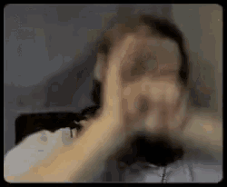 a blurry picture of a person 's face with their hands in the air