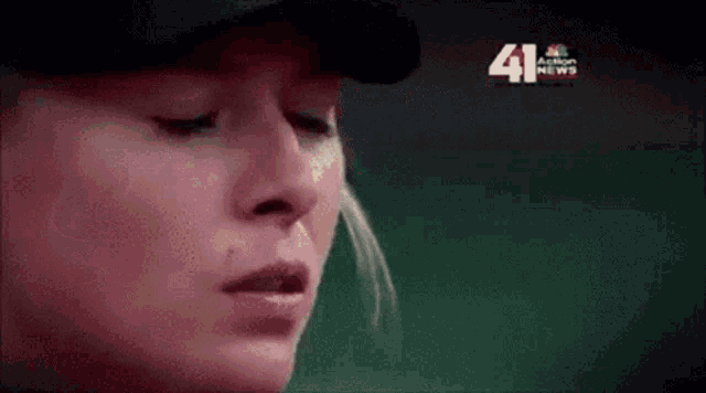 a close up of a woman 's face with the number 41 in the corner