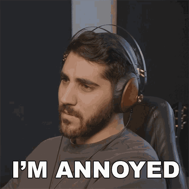 a man wearing headphones has the words " i 'm annoyed " below him