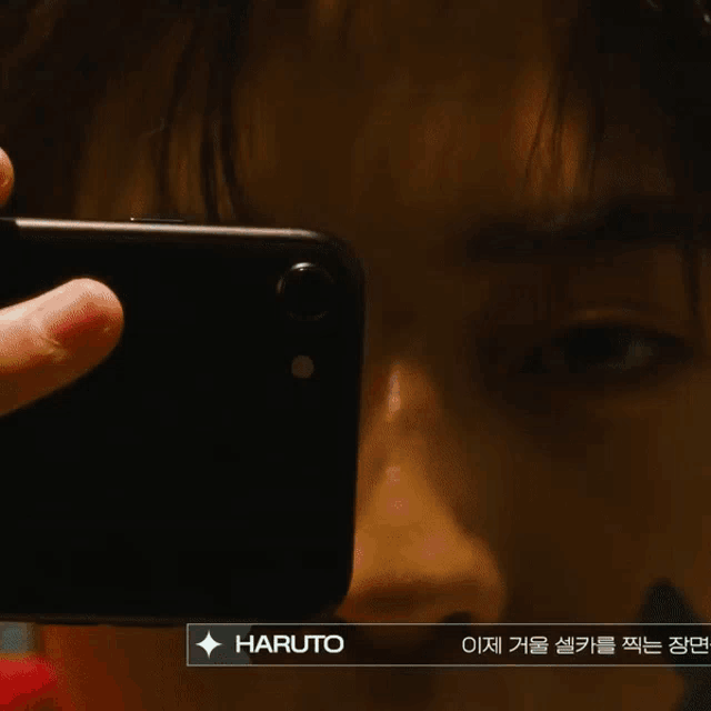 a person is taking a picture with their phone and the name haruto is visible